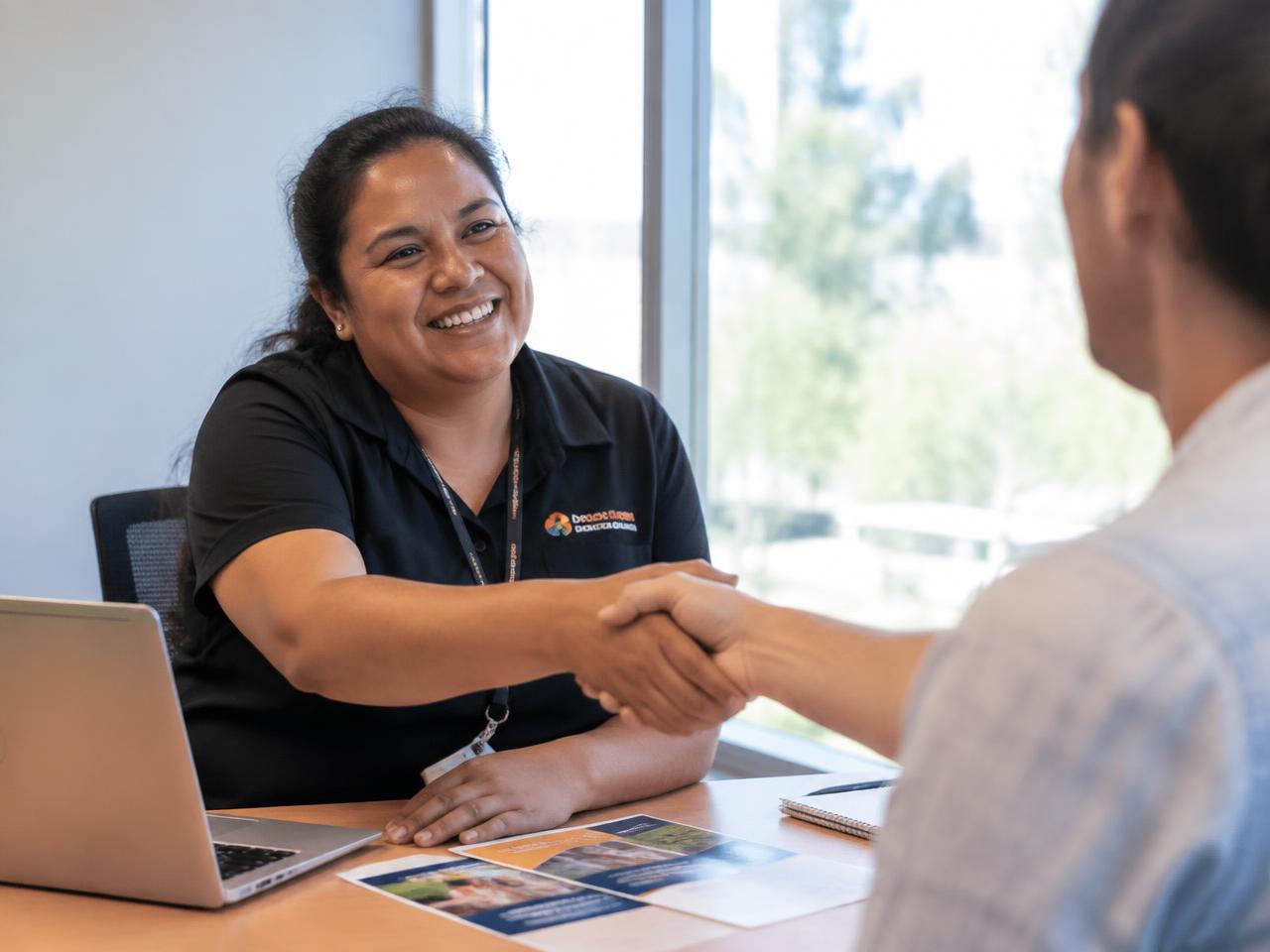 A provider team member and participant talking together in a community setting